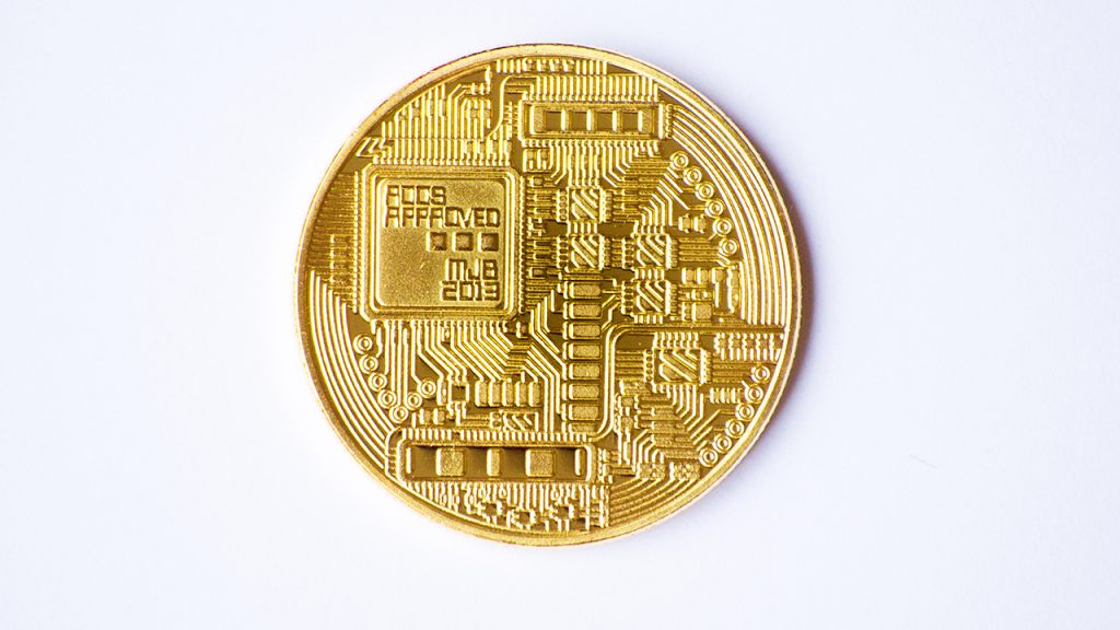 A coin engraved with a circuitboard.