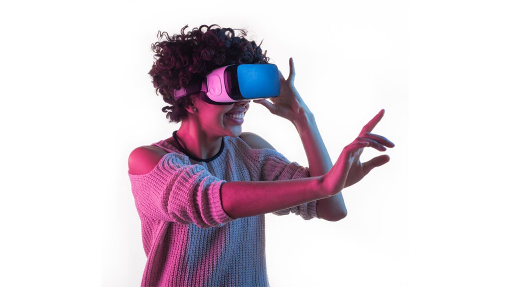 A woman uses a virtual reality headset.