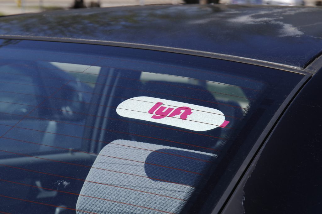 Lyft's logo on a car windshield.
