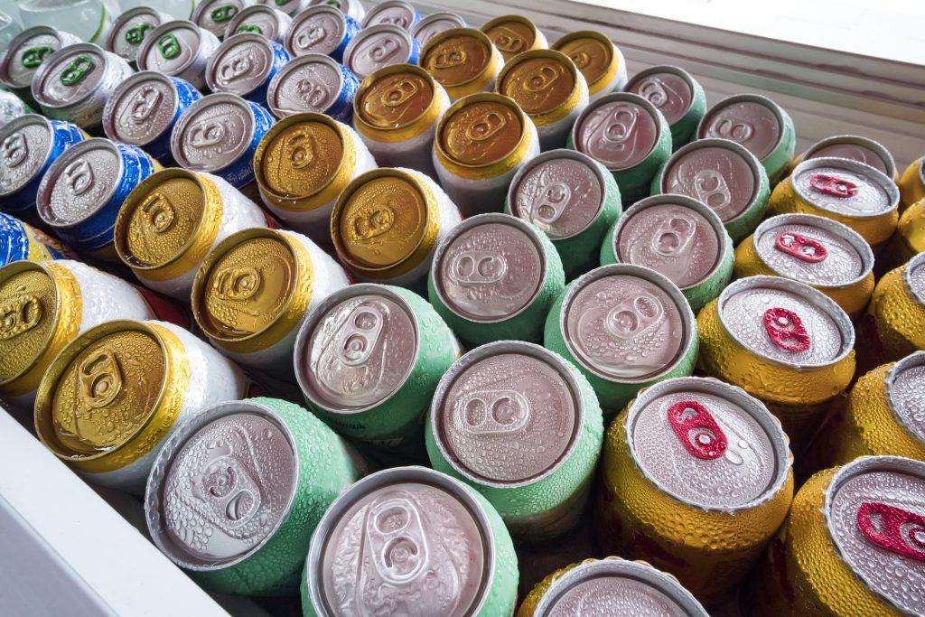 Different varitiies of canned beverages arranged in a cooler.