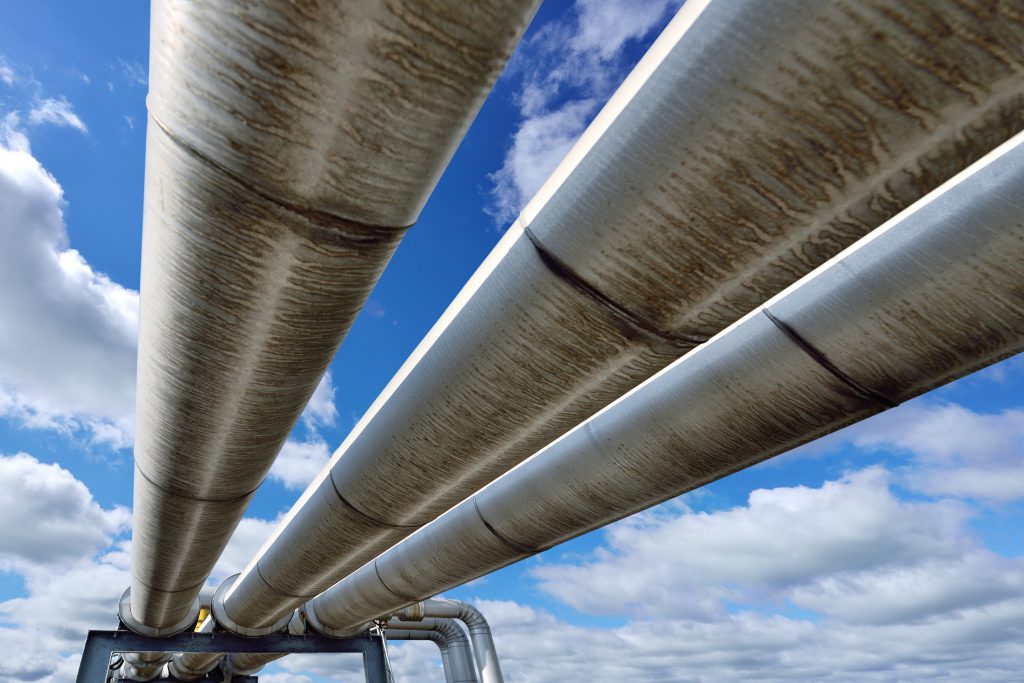 Three pipelines against a sky background.